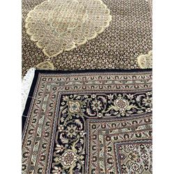 Persian Mahi design ground rug, pole medallion on black field with repeating design, enclosed by triple guarded border 298cm x 202cm