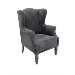 Early 20th century wing back armchair, upholstered in navy blue fabric, raised on turned and reeded front supports W69cm