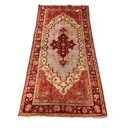 Persian design red ground rug, pole medallion on cream field enclosed by border 105cm x 225cm