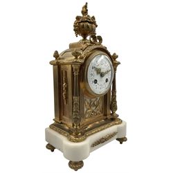 Cherillier - Paris, late 19th century brass cased 8-day mantle clock on a white marble base, break arch top with non matching finials surmounted by an oval bowl festooned with flowers, enamel dial with retailers name, Arabic numerals and floral swags, pierced Louis XV gilt hands within a convex glass and brass bezel, twin train rack striking movement striking the hours and half hours on a bell. With key and pendulum.  
