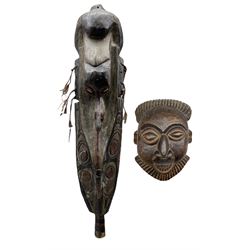 A large Papua New Guinea Latmul Mei carved mask with pigment decoration, cowrie shell eyes and fibre ornamentation, H106cm, together with an African carved mask (2)