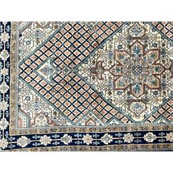 Persian Hamadan blue and sage green ground rug, central floral medallion in pale ground lozenge, the field decorated with stylised leaf motifs, five band border decorated with geometric patterns and stylised plant motifs