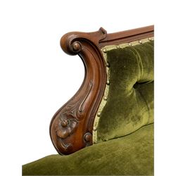 Victorian mahogany chaise longue, moulded shaped frame decorated with carved flower heads and extending foliage, upholstered in buttoned green fabric, shaped arms and cabriole supports with scroll carved terminals, on brass castors