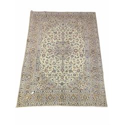 Persian Kashan hand knotted ivory ground carpet, decorated with interlaced scrolling foliate all over 330cm x 245cm