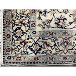 Persian Nain ivory ground rug, the field with a central floral medallion surrounded by scrolling tendrils of branches with palmettes and stylised bouquets of flower heads, the multi-band border with repeating floral patterns and leafage