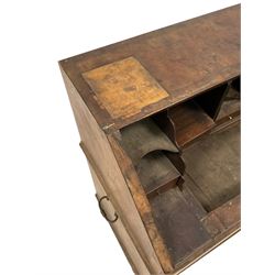Early 18th century walnut bureau, the fall front enclosing interior fitted with small drawers, pigeon holes and divisions, two short drawers over two long drawers, fitted with wrought metal handles to each side - in need of extensive restoration 
