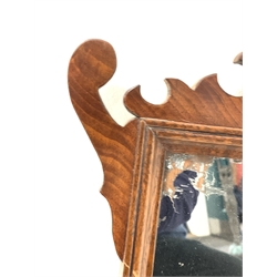 Edwardian burr walnut framed wall hanging mirror with decorative pediment and apron, (66cm x 38cm) together with another similar wall hanging mirror, (63cm x 42cm)