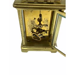 An early 20th century eight-day French Corniche cased timepiece carriage clock with a platform cylinder escapement, bevelled glass panels to case and a glass panel to the top of the case, white enamel dial with Roman numerals and minute markers, spade hands, dial inscribed 