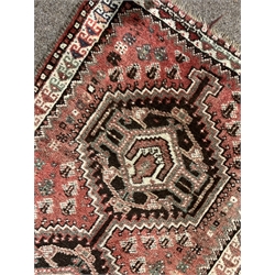 Persian hand knotted red ground rug with double pole medallion, field decorated with stylised motifs, dog tooth inner border, 134cm x 89cm