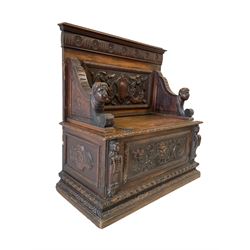 18th century style oak settle, the back panel with carvings of mermaids and folate decoration with masked arms over hinged seat and base with foliate and mask carving
