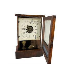 A German and American 19th century 30-hour alarm clock - German Bavarian carved case with a crenellated top and decorative turrets on a rectangular carved plinth with four pad feet, two train movement with alarm, paper dial with Roman numerals, spade hands and brass alarm setting disc to the centre, visible pendulum marked RA, sounding the alarm on a bell. H36 W27 D14.
An American 