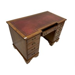 Merryweather of Holloway London - early Edwardian mahogany twin pedestal breakfront desk, inset leather writing surface, fitted with central frieze drawer and flanked by eight graduating drawers, bracket feet with castors
