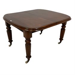 Victorian mahogany extending dining table, moulded rectangular top with rounded ends, telescopic extending action with two additional leaves, on turned and reed carved supports with brass and ceramic castors, with winder 