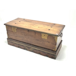 20th century oak coffer, studded hinged lid revealing interior fitted with candle box, wrought iron carry handle to each end, peirced brass mounts over skirted base with floral carved details, W13cm