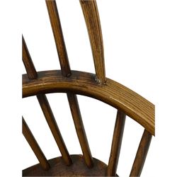 19th century Windsor chair, the splat and spindle back over elm seat, raised on turned supports, united by a stretcher 