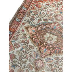 Persian pale ground rug, central medallion in field of trailing branch and plant motifs, the spandrels decorated with flower head motifs, repeating border