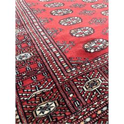 Persian design ground rug, ivory field with border, (140cm x 96cm) together with a Bokhara design ground rug (170cm x 95cm) and a Chinese washed wool ground rug (210cm x 120cm) 