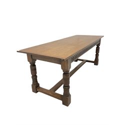 Oak refectory table, the rectangular top over carved frieze, raised on turned and square supports, united by a stretcher W199m, H75cm, D76cm