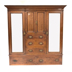 Edwardian walnut triple wardrobe, dentil cornice over two inlaid panelled doors and three graduated drawers, flanked by two mirrored doors enclosing interiors fitted for hanging, two drawers under, W189cm, H192cm, D57cm
