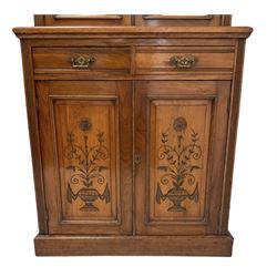 Edwardian walnut bookcase on cupboard, the projecting cornice over two glazed doors, two drawers and two cupboards, raised on a plinth base W90cm, H222cm, D44cm 