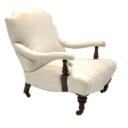 Victorian low upholstered open armchair, with swept arms, raised on turned front supports and castors, W68cm