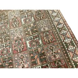 Persian Gabbeh Bakhtiari rose ground garden rug, the field decorated with square panels containing stylised palmette and urn motifs with floral symbols, the guarded border with repeating interlocking geometric shapes
