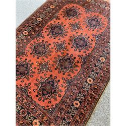 Afghan rug with a double row of geometric panels on red field with borders