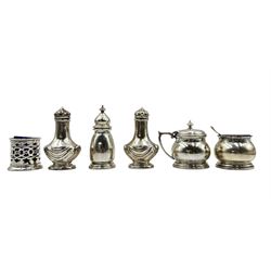 Silver three piece condiment set Birmingham 1941, pair of silver pepperettes with embossed decoration and a silver circular salt (6) 