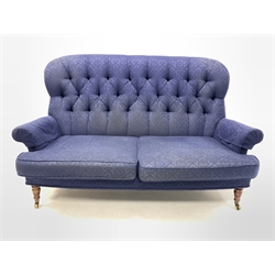 Liberty of London - Victorian style two seat sofa, upholstered in deep buttoned blue floral damask fabric, raised on turned supports and castors 