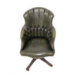 George III design swivel desk elbow chair, upholstered in dark olive green buttoned leather with studwork, raised on quadripod base with castors