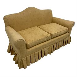 Victorian design two seat humpback sofa, sprung back and seat upholstered in yellow foliate patterned damask fabric, on turned supports united by stretcher
Provenance: From the Estate of the late Dowager Lady St Oswald