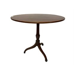 George III mahogany tilt-top occasional table, oval top over turned vasiform pedestal terminating in splayed tripod base with arcade carving and mahogany stringing, terminating in spade feet