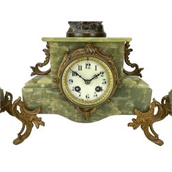 French - late 19th century green onyx 8-day clock garniture, rectangular stepped case with gilt mounts raised on scroll feet, pediment surmounted by a painted faux bronze figure of an angel, Parisian drum movement with an enamel dial, Arabic numerals, steel hands and minute track,  twin train countwheel striking movement, striking the hours and half hours on a bell. With conforming garni entitled Le travail and Le commerce. Garni Height 40cm