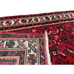 Large Persian Hosseinabad crimson ground runner rug, the field decorated with all-over geometric motifs, the multi-band ivory border with repeating stylised shapes