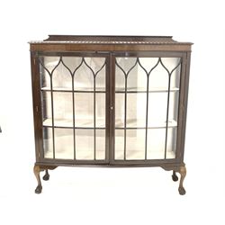 Early 20th century mahogany display cabinet, two doors enclosing two shelves, raised on ball and claw supports 