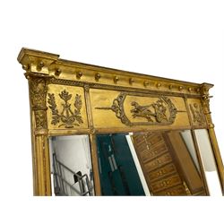 Regency giltwood and gesso overmantel mirror, projecting cavetto cornice decorated with globular mounts, the central frieze panel decorated with Classical chariot scene within foliate borders, the flanking panels with lyres and trailing oak leaf and acorns, three bevelled mirror plates enclosed by reeded half columns with Composite capitals