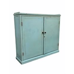 Late 19th/ early 20th century painted pine kitchen larder cupboard, panelled doors enclosing two shelves, raised on a skirted base W140cm, H127cm, D38cm