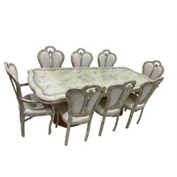 Italian composite marble extending dining table, serpentine top in onyx beige finish with gilt scrolling design, supported by twin pedestals in a neo-classical urn style (230cm x 104cm x 76cm); Set eight (4+2) composite marble dining chairs, arched cresting rail with upholstered back and seat decorated with cream foliate pattern (55cm x 56cm x 106cm)