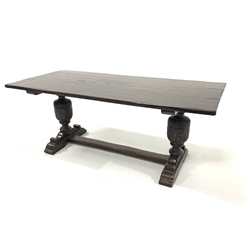 Early 20th century dark oak refectory style dining table, plank top raised on baluster turned leaf carved columns and sledge supports united by stretcher, 194cm x 86cm, H76cm