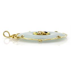 Gold circular jade pendant with central gold and stone set decoration, stamped 14K