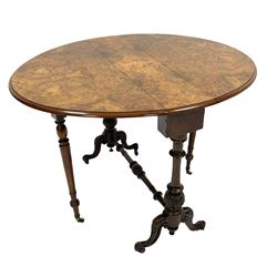 Victorian figured walnut stretcher table, oval drop leaf top with moulded edge and book matched veneers, on twin turned pillar supports carved with foliate, joined by turned and carved stretcher, scroll and leaf carved splayed supports, gate-leg action base with turned supports, brass and ceramic castors  