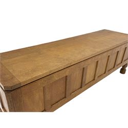 'Mouseman' oak blanket chest, rectangular adzed hinged lid over panelled front, panelled sides and back, on octagonal feet, by Robert Thompson of Kilburn 