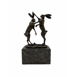 A bronze figure group, modelled as two male hares boxing, upon a naturalistic base signed Nick and with foundry mark, raised upon a rectangular base, overall H24cm