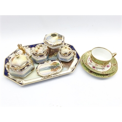 Noritake dressing table set decorated with a lake landscape within a blue and gilt border, seven pieces, and a Noritake trio decorated in flowers and gilt