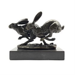 Bronze figure group, modelled as two hares in chase, H12cm overall