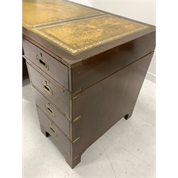 20th century Campaign style mahogany twin pedestal desk,  the top with inset  tooled  leather writing surface over one long and eight short drawers with recessed brass handles, raised on shaped bracket supports, 137cm x 68cm, H78cm