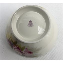 Early 20th century Royal Worcester fruit bowl by Reginald Austin, hand painted throughout with roses on a faded green ground, signed R. Austin to the exterior, with puce printed marks beneath including date code for 1926, D22cm, together with a early 20th century Royal Worcester ewer vase, high loop handle with dolphin terminal, hand painted with flowers and foliage, on circular foot,  with puce printed marks beneath including shape number 2441, and date code for 1912, H17.5cm (2) 