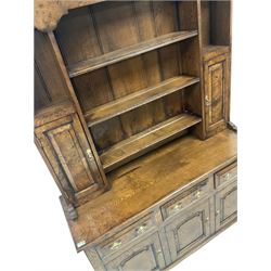 18th century style pollard oak dresser, the three height plate rack with projecting cornice over shaped apron, two open shelves and two spice cupboards, three drawers and three cupboards to base, raised on bracket supports W140cm