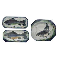Three Scottish Highland Stoneware dishes or wall plaques, each of rectangular canted form, painted with a Salmon within a sponged border, W44cm max 