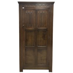 18th century design oak hall wardrobe, the moulded cornice over one hinged door with linen fold carved panels, opening to reveal interior fitted for hanging, raised on stile supports 